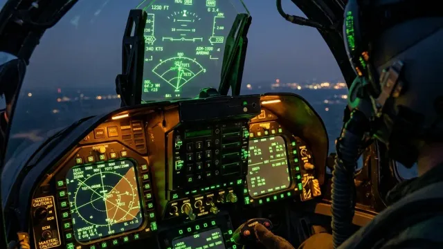 Fighter cockpit avionics and heads-up display at dusk